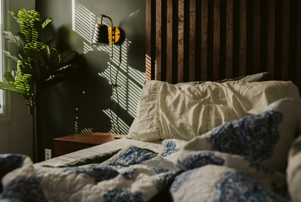 Unmade bed in soft morning light after a slow start to the day