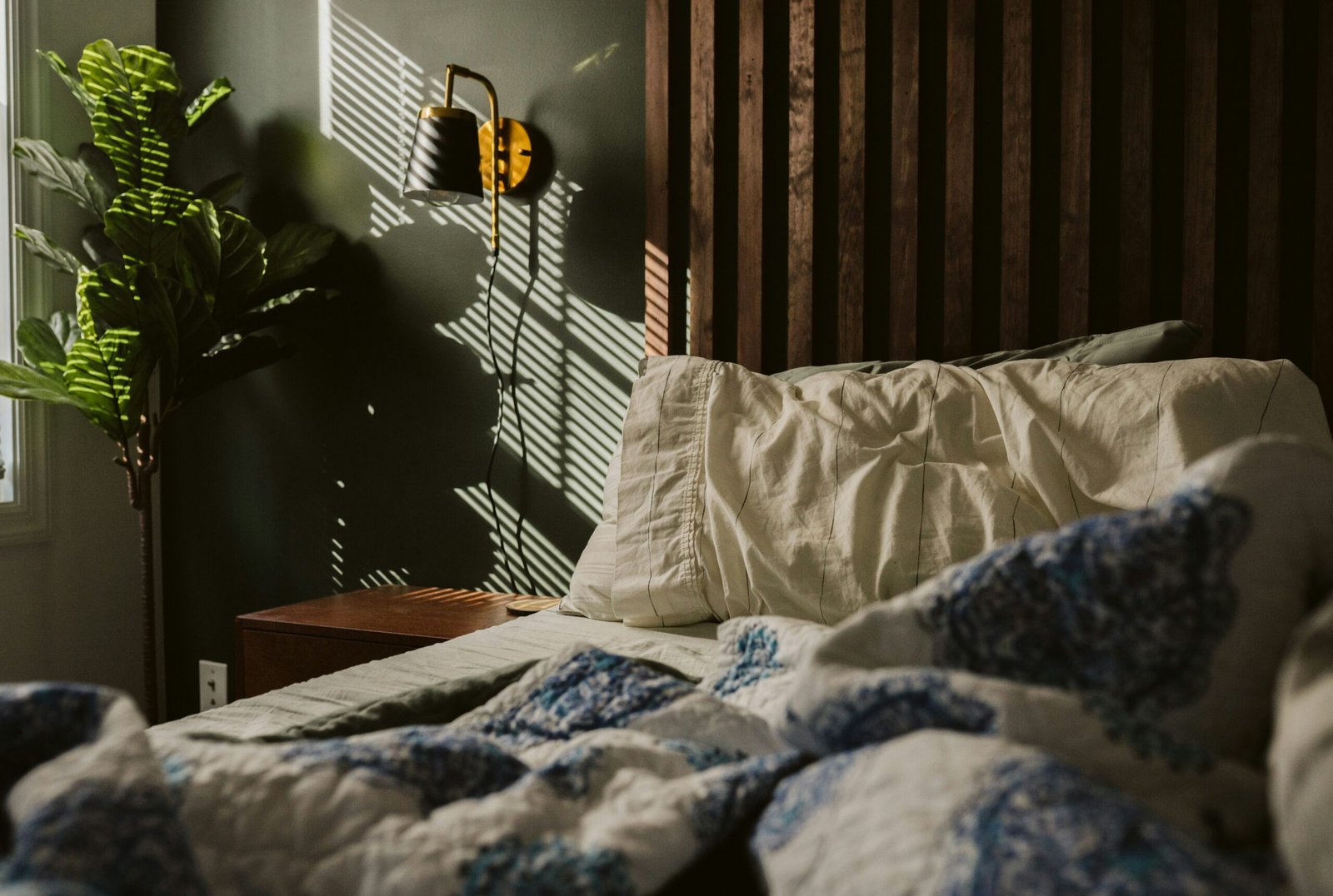 Unmade bed in soft morning light after a slow start to the day