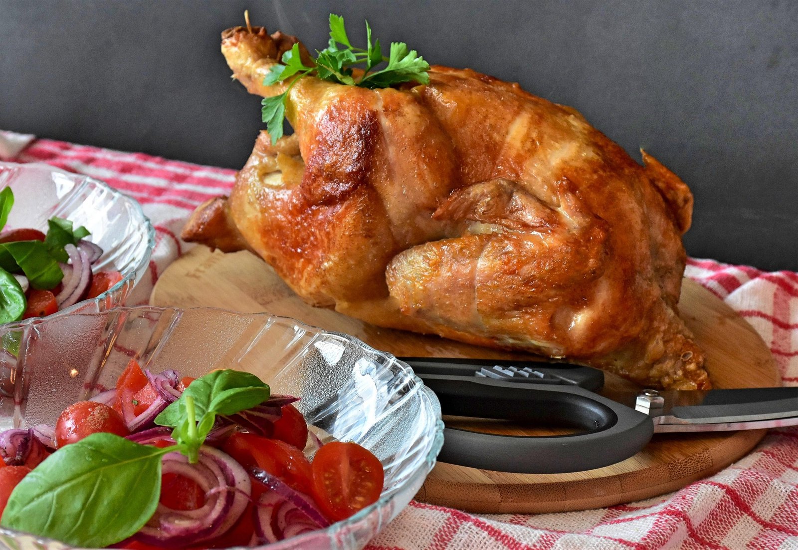 Alt Text: Roast chicken served with a fresh tomato and onion salad